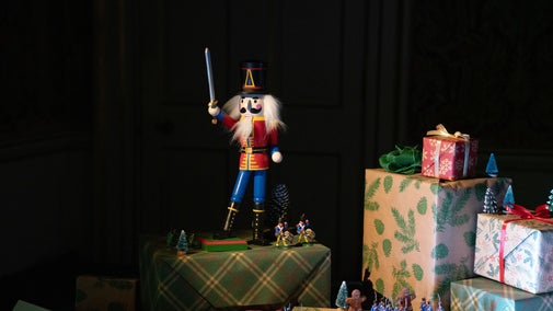 A nutcracker amongst a pile of presents